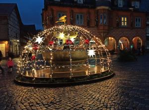 a fountain covered in christmas lights in a street at Fewo Zeier in Goslar