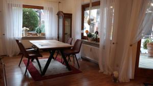 a dining room with a table and chairs and a window at Fewo Zeier in Goslar +8 photos