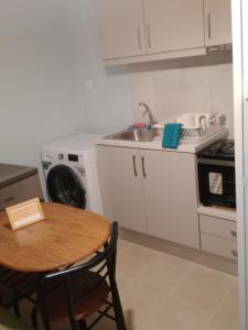 a small kitchen with a table and a sink at Christos ΙΙΙ in Asvestokhórion