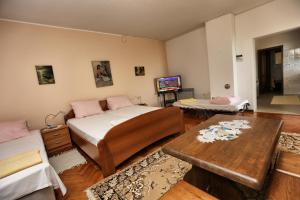 a bedroom with a bed and a table and a tv at Villa Vera in Ičići