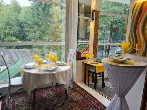 a dining room with two tables and a large window at Roomantic Apartments in Bromberg