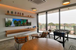 a room with a ping pong table and some windows at Just 100 meters from Shopping del Sol in Asuncion