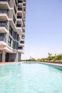 a swimming pool in front of a building at Just 100 meters from Shopping del Sol in Asuncion