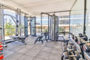 a gym with treadmills and machines in a building at Stylish Retreat Steps from Shopping del Sol in Asuncion