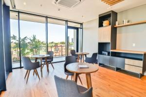 a meeting room with tables and chairs and windows at Stylish Retreat Steps from Shopping del Sol in Asuncion