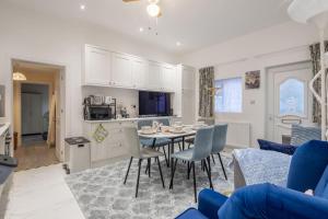 a kitchen and living room with a table and chairs at Newly refurbed 3Bed Annexe - With Parking! in Albury