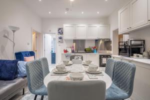 a living room with a table and chairs and a kitchen at Newly refurbed 3Bed Annexe - With Parking! in Albury +21 photos