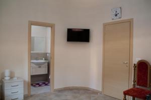 a bathroom with a sink and a television on a wall at The Liberty Palace in Campobello di Licata +44 photos
