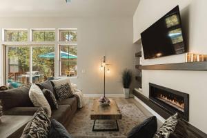 The Reel Deal, Luxury Family Cabin by Alpine Slide في بيغ بير لاكي: غرفة معيشة مع أريكة ومدفأة