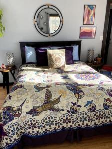 a bedroom with a bed with a quilt with birds on it at Gorgeous Coal Creek Canyon Guest Suite in Coal Creek