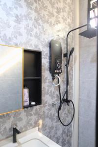 a bathroom with a sink and a phone on the wall at Homestay Tokki Tanah Merah in Tanah Merah +11 photos