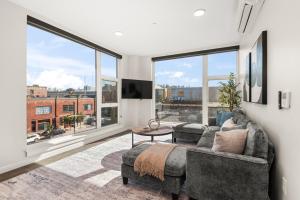 a living room with a couch and a large window at 2BR Cozy Apartment in DT in Spokane