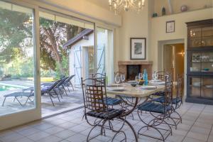 a dining room with a table and chairs at Villa Roumentas - 8 pers - Vue vallée & Piscine in Navailles-Angos