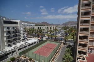 a tennis court in the middle of a city at Apartamento Tenerife Sur in Playa de las Americas