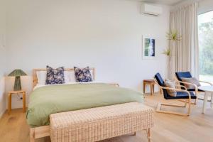 a bedroom with a bed and a table and chairs at Ideally Located Modern Studio Apartment in Dunsborough