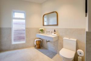 a bathroom with a sink and a toilet and a mirror at Ideally Located Modern Studio Apartment in Dunsborough +14 photos