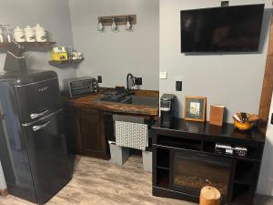 a kitchen with a sink and a refrigerator at Ellison Funny Farm in Barrière