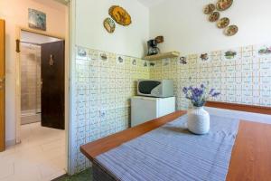 a kitchen with a vase of flowers on a table at House Igor in Ledenice