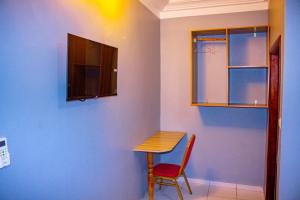 a room with a table and a table and a chair at West Hotel Douala in Bonabéri +25 photos