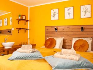 two beds in a room with yellow walls at Eric the Red Guesthouse in Reykjavík