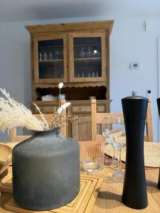 a table with two black vases and glasses on it at Frangines & Compagnie in Hotton