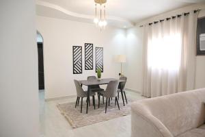 a dining room with a table and chairs at vatoran appartment elkaldiha in Al Madinah +55 photos