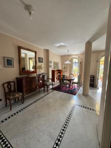 a living room with a table and a mirror at La Terrazza in Viareggio