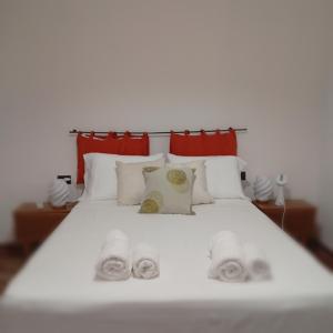 a large white bed with towels on it at Las Marias in San Fernando del Valle de Catamarca