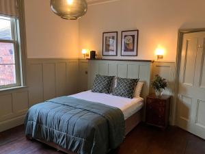 a bedroom with a bed with two pillows on it at The Saltburn Townhouse in Saltburn-by-the-Sea