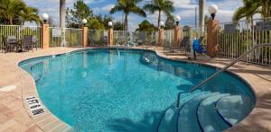 a large swimming pool with blue water in a resort at Fairfield Inn & Suites by Marriott Venice in Venice