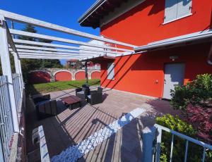 a patio of a house with a red building at B2In Suite & Office in Capriate San Gervasio