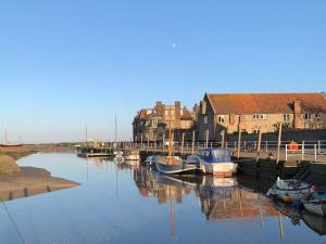 a group of boats are docked in a harbor at Saltkettle Sanctuary, Blakeney By Together Travel in Blakeney