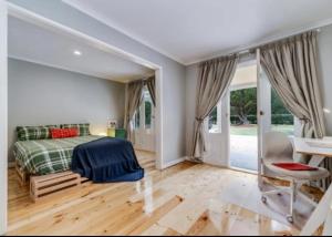 a bedroom with a bed and a desk at The Pond House Trentham in Trentham