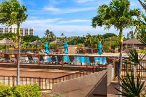a resort with chairs and umbrellas and a pool at Maui Eldorado Condo G201 in Kaanapali