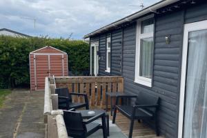 a patio with chairs and a table and a house at 2Bed Chalet Sleeps 4- Garden Balcony Pets Beach in Bridlington