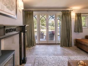 a living room with a fireplace and a sliding glass door at FORGETMENOT COTTAGE FOR TWO - Wells-next-the-Sea in Wells next the Sea +10 photos