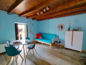 a living room with a blue couch and a table at Urdaibai alojamientos en reserva de la biosfera in Isla Becoa +18 photos