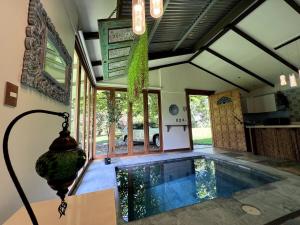 a house with a swimming pool in a room at Casa Bali in San Francisco de Palmera
