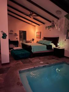 a bedroom with a bed and a swimming pool at Casa Bali in San Francisco de Palmera