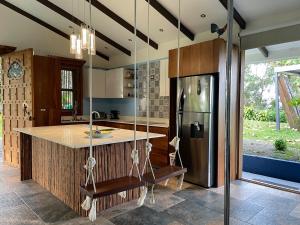 a kitchen with a refrigerator and a center island at Casa Bali in San Francisco de Palmera +31 photos