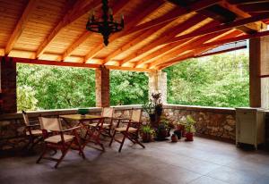 a screened in porch with a table and chairs at Bridge View Cottage in Podhokhórion