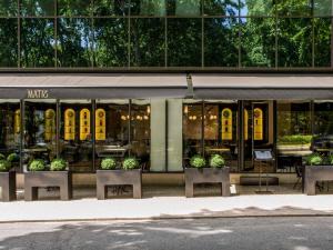 a store front of a building with potted plants at Sofitel Lisbon Liberdade in Lisbon