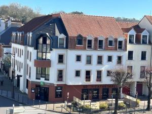 a large white building with a red roof at ibis Styles Boulogne sur Mer Centre Cathédrale in Boulogne-sur-Mer