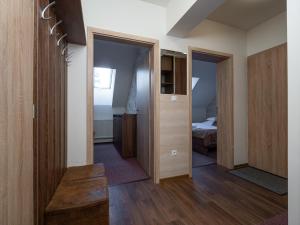 a room with wooden doors and a bedroom at Apartment No.28 Jasná in Belá