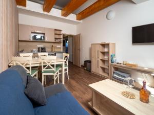 a living room with a blue couch and a dining room at Apartment No.28 Jasná in Belá