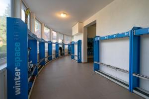 a hallway with blue stalls in a building at Apartment No.28 Jasná in Belá