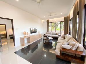a living room with a couch and a table at Lovina Seaview Hill Villa in Lovina
