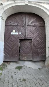 a large wooden garage door in a building at Reghin Ultra Central in Reghin
