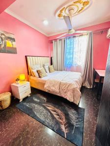 a bedroom with pink walls and a bed and a window at The central Heartbeat Haven Intercity 1 in Dar es Salaam +42 photos