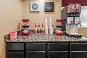 a kitchen counter with a coffee maker and bottles on it at Red Roof Inn Columbus West - Hilliard in New Rome